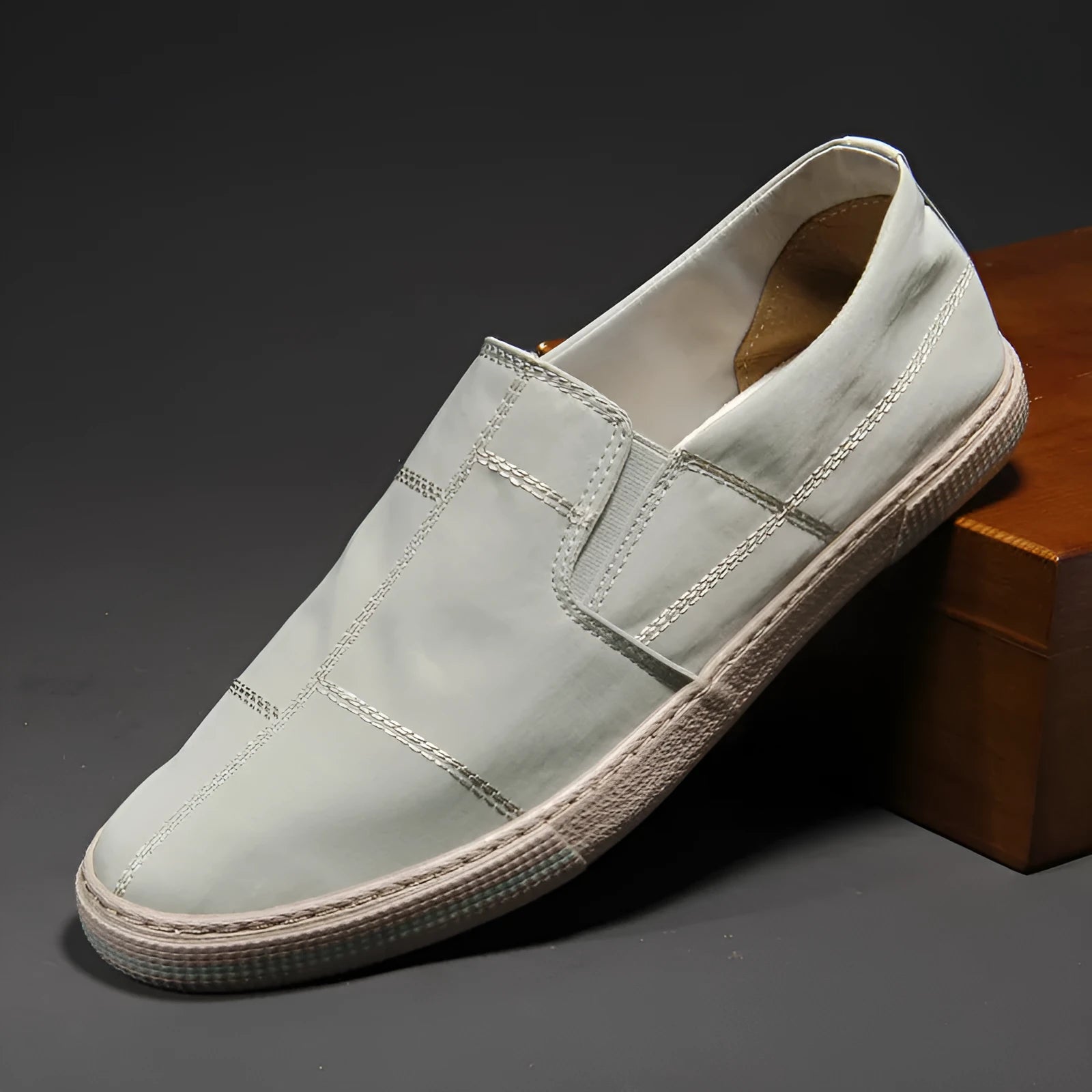 Men's low-top slip-on canvas shoes in various colours showing round toe and vulcanised rubber sole.