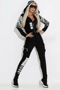 Black women's printed casual suit with hooded zip-up top and matching trousers.