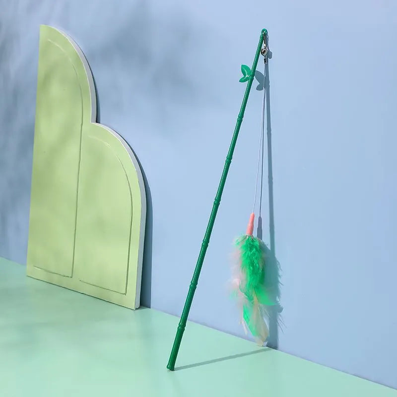 Green interactive cat feather wand toy with bells and a comfortable grip handle