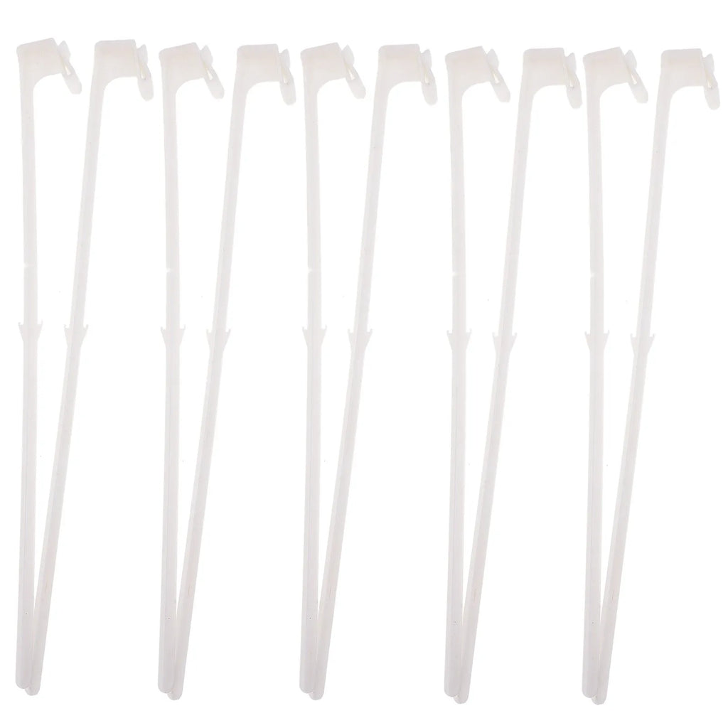 Ten white plastic car window flag pole clip mounts laid out on a surface.