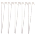 Ten white plastic car window flag pole clip mounts laid out on a surface.
