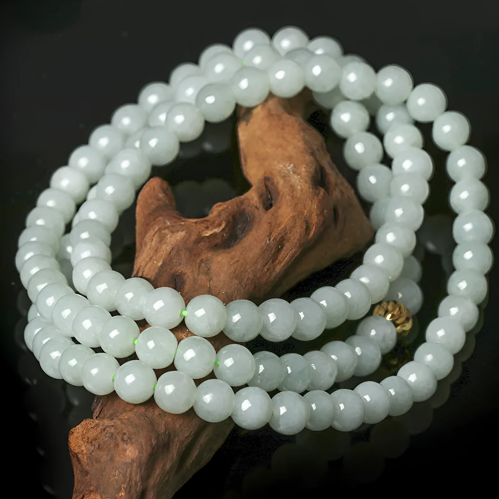 Adjustable necklace with a round white and green jade bead on a silver chain.