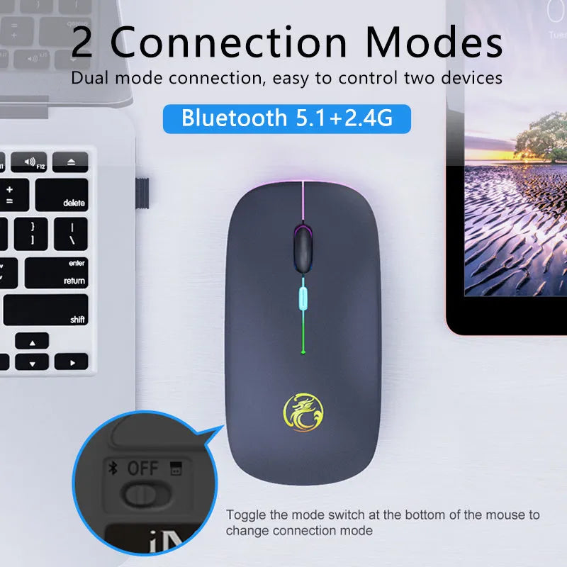 Black and white dual-mode wireless silent mouse with USB charging cable on a desk.