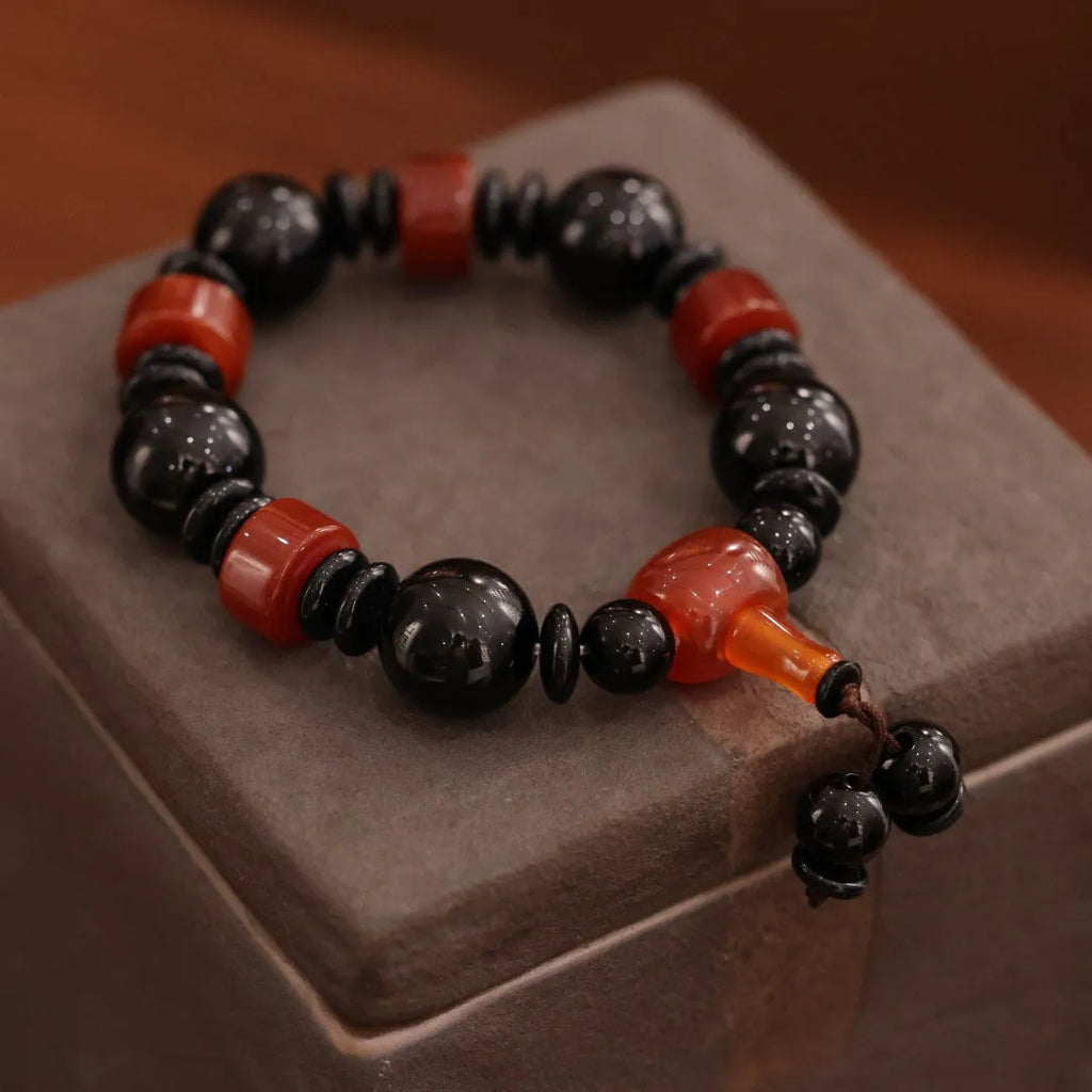 Old agate bracelet with A13 sardonyx bead, white agate spacers, and red agate barrel bead in geometric ethnic design