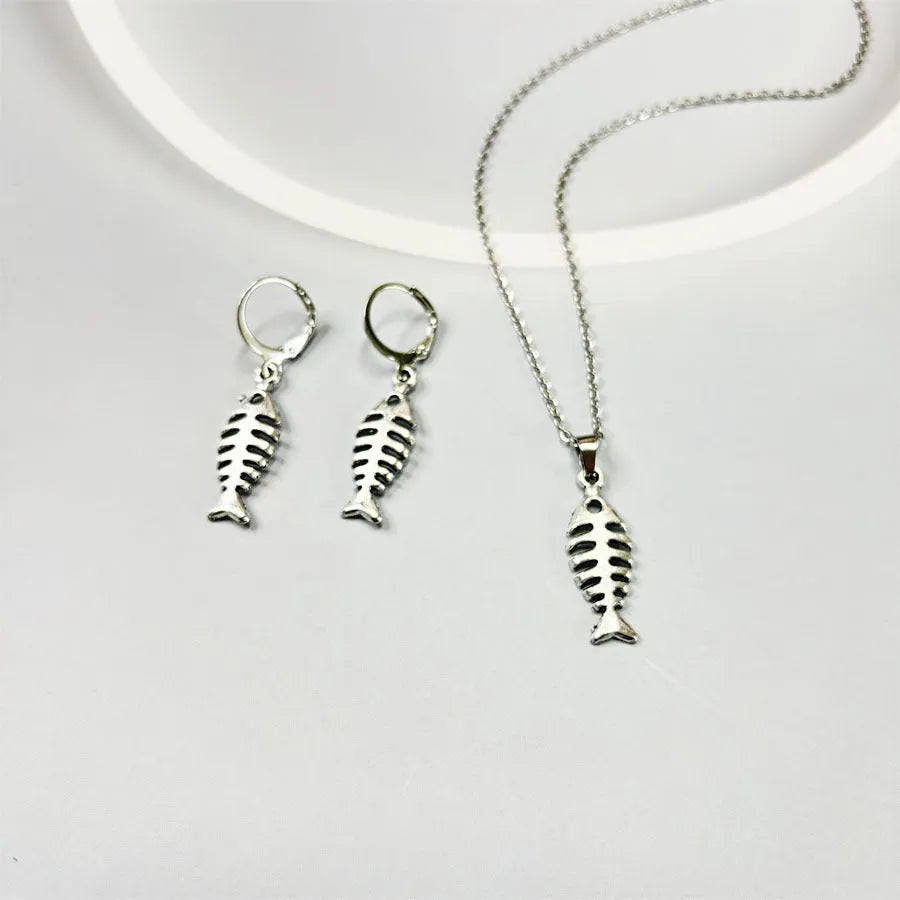 Women's vintage fishbone pendant necklace and matching earrings set with adjustable chain.
