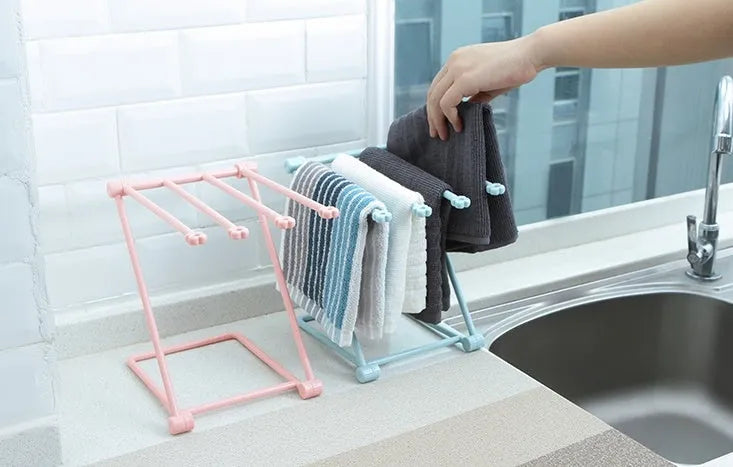 Light grey foldable plastic dishcloth shelf on a kitchen countertop