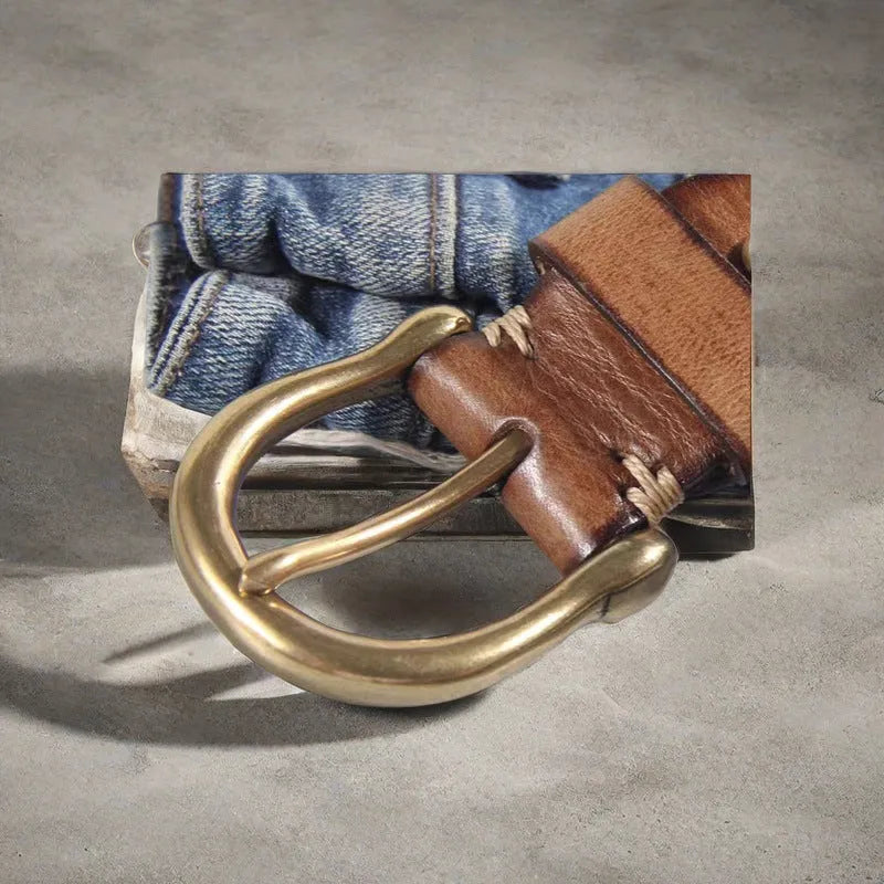 Men's brown casual leather belt with a copper pin buckle on a textured background.
