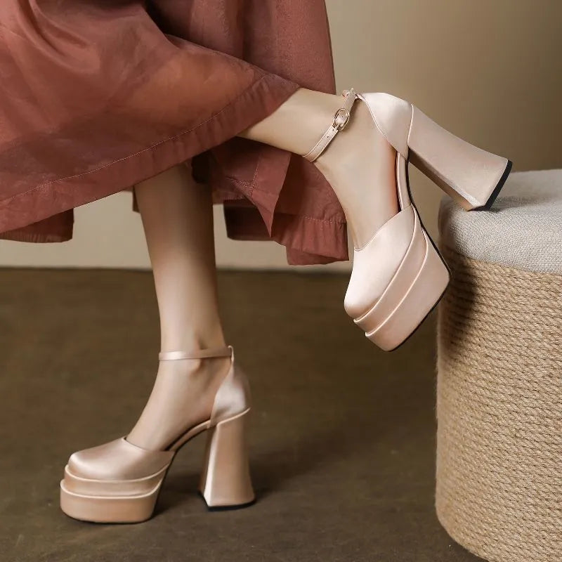 Women's white waterproof platform pumps with a chunky block heel and round toe on a neutral background.