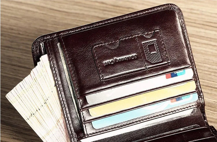 Men's black leather wallet open, showing internal card slots, photo slot, change pocket and hidden compartment.