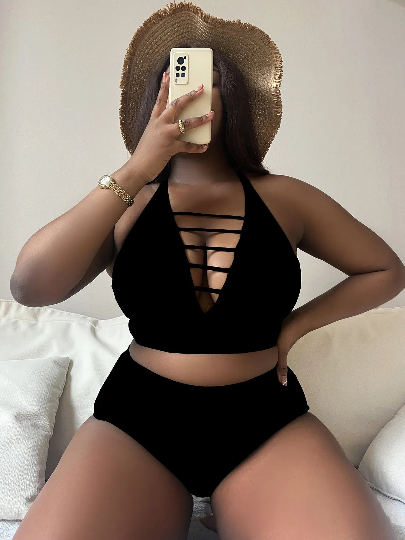 Plus size black halter bikini with adjustable straps and high-waist briefs on a mannequin.