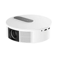 White HD projector unit with remote control on a table for home cinema use.