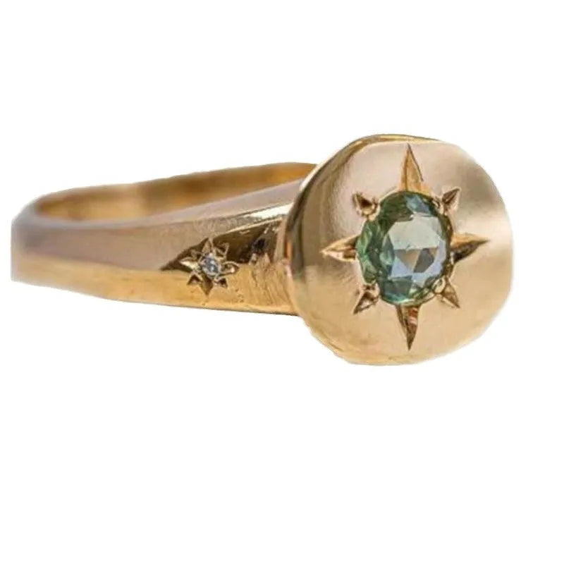 Gold coloured adjustable star ring with oval asterism zirconia stone.