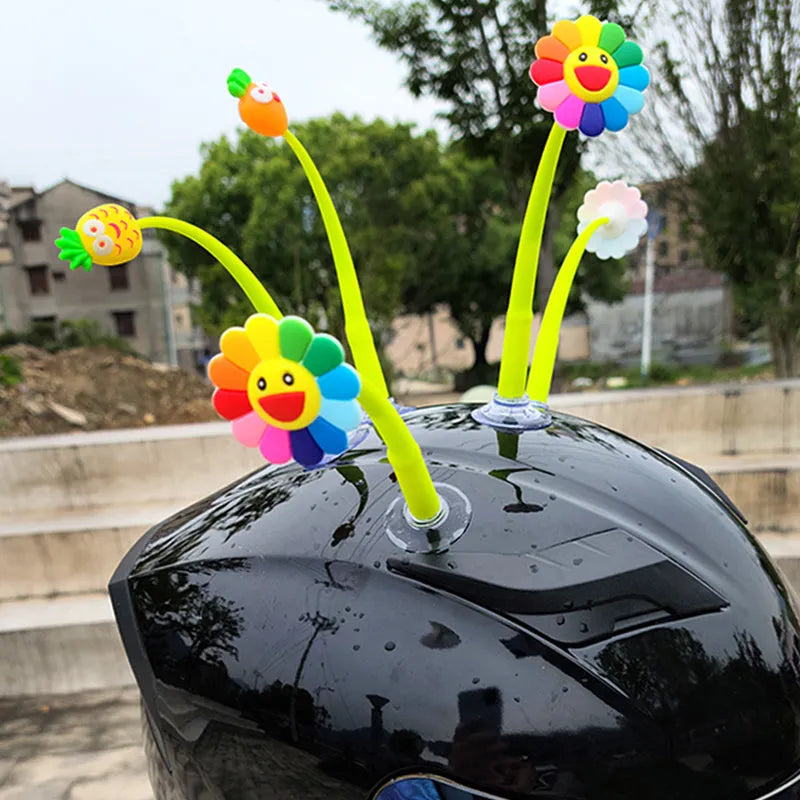 Yellow sunflower silicone decoration with a suction cup base for attaching to a helmet.