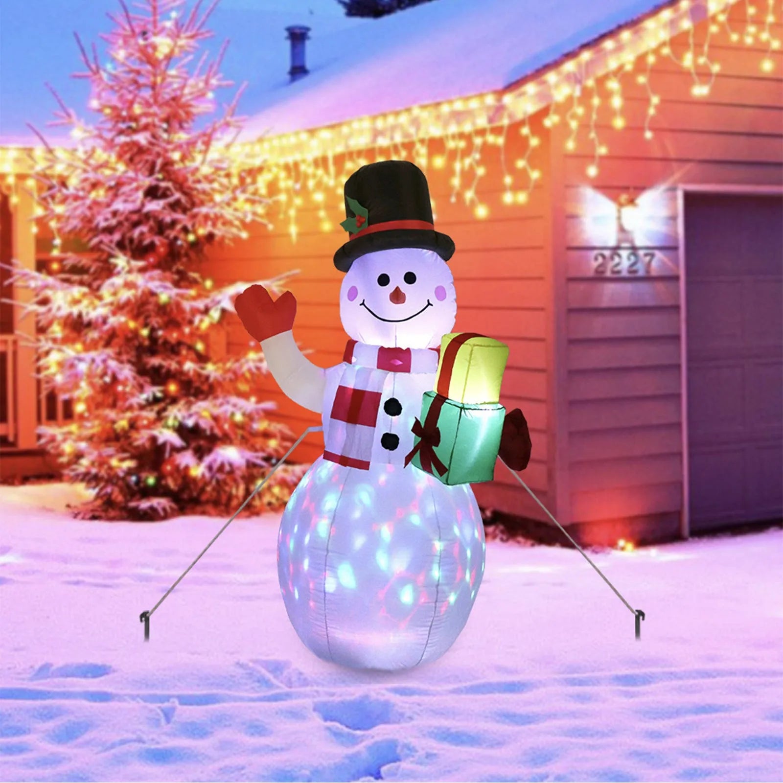 Glowing LED inflatable Christmas decorations including Santa, snowman, and a Christmas tree for outdoor garden use.