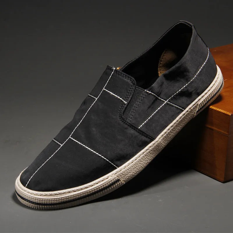 Men's low-top slip-on canvas shoes in various colours showing round toe and vulcanised rubber sole.