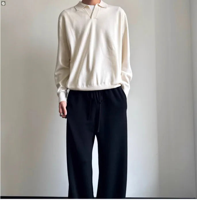 Man wearing a milky white pure wool polo sweater with a lapel collar, showcasing its loose fit.