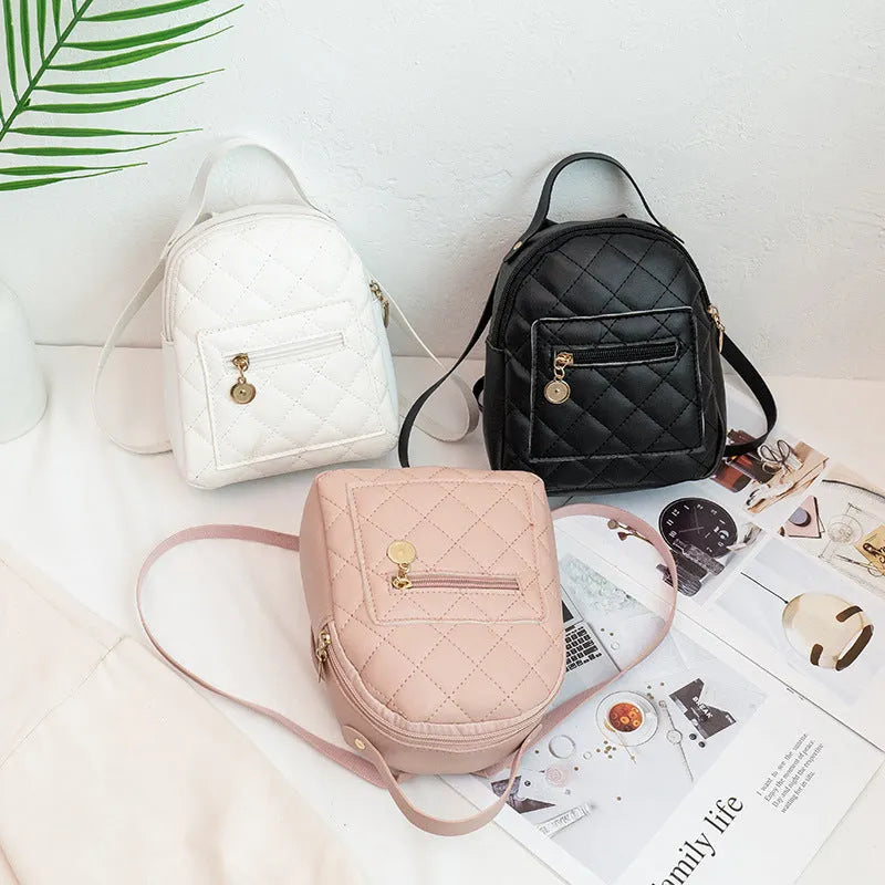 Hard square vertical girls' backpack in PU with embroidery, showing front sandwich pocket and soft carry handle.
