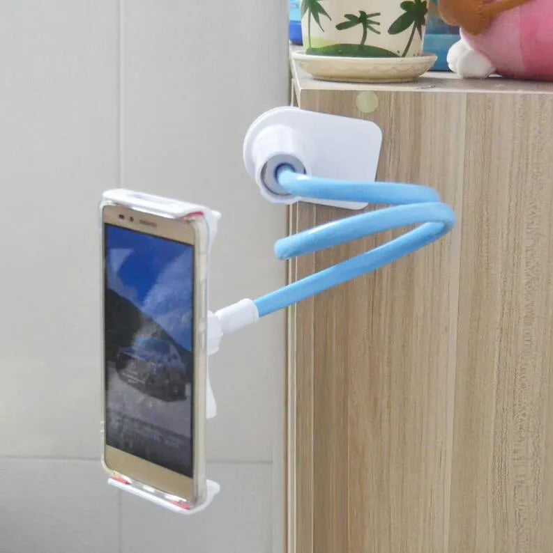 Black bedside oversize flat panel phone holder with long flexible arm mounted on a wooden table.