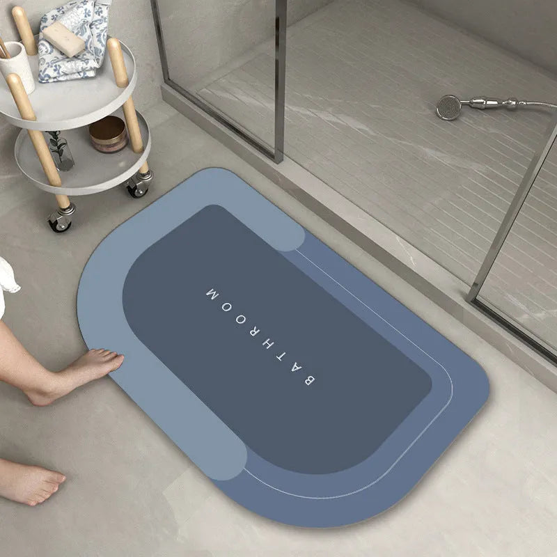 Diatom mud absorbent bathroom floor mat in blue rectangular shape on tiled floor