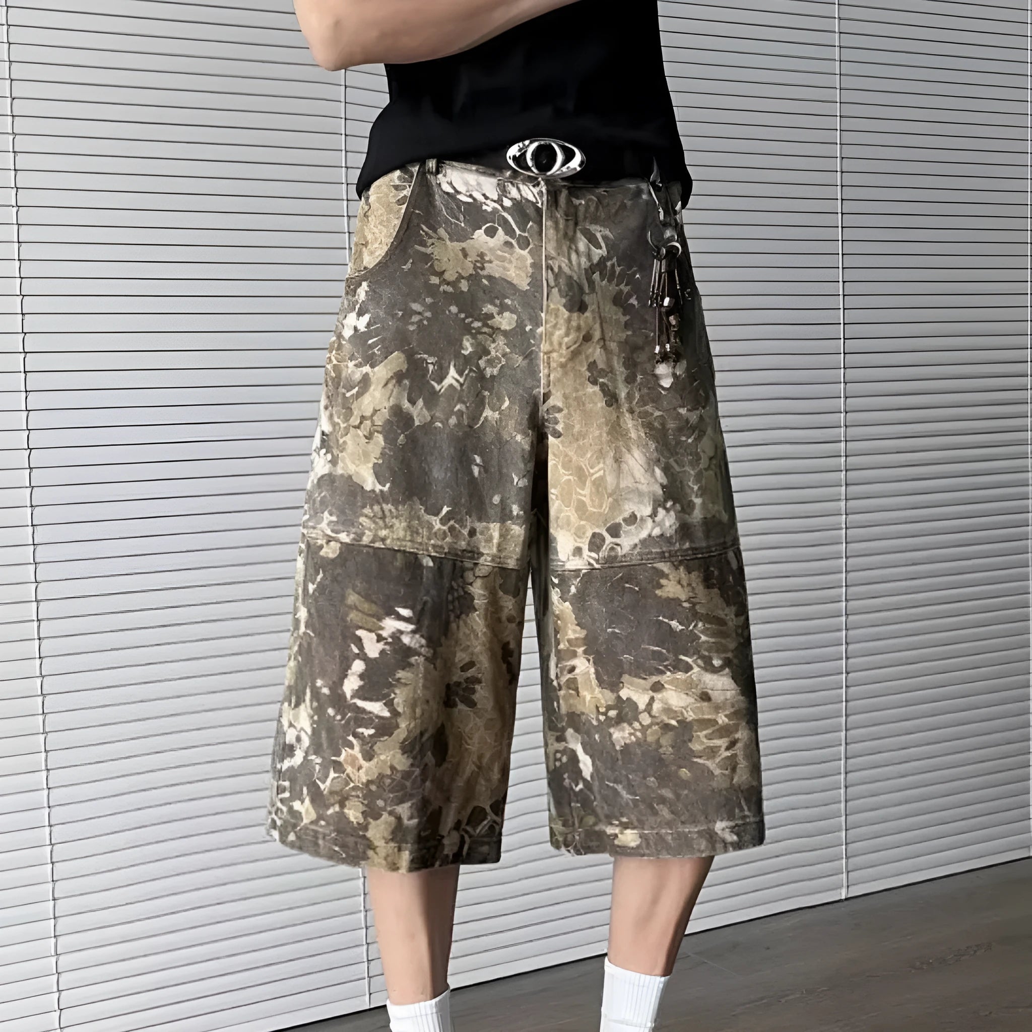Yellow women's jeans with snake camouflage pattern and cropped leg length.