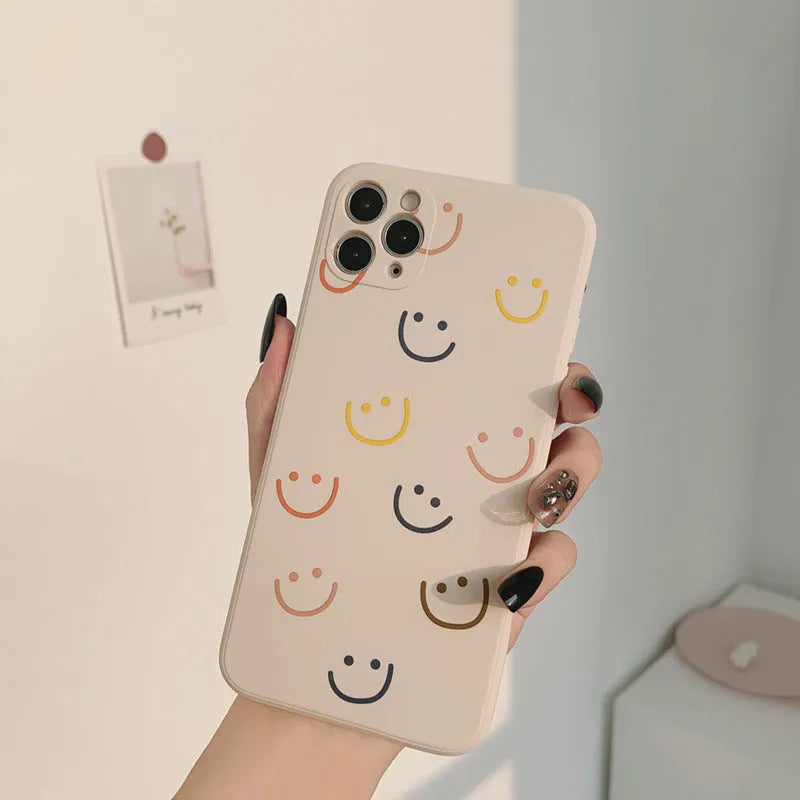 Simple TPU iPhone case with painted smiley face design in three colour options
