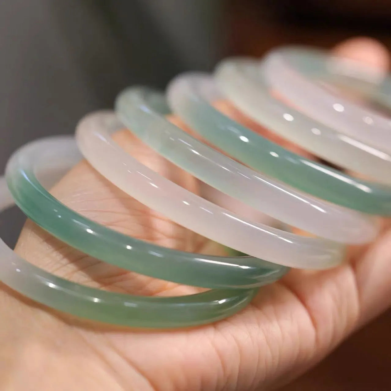 Chalcedony jade bracelet with carved southern mountain and water landscape motif.