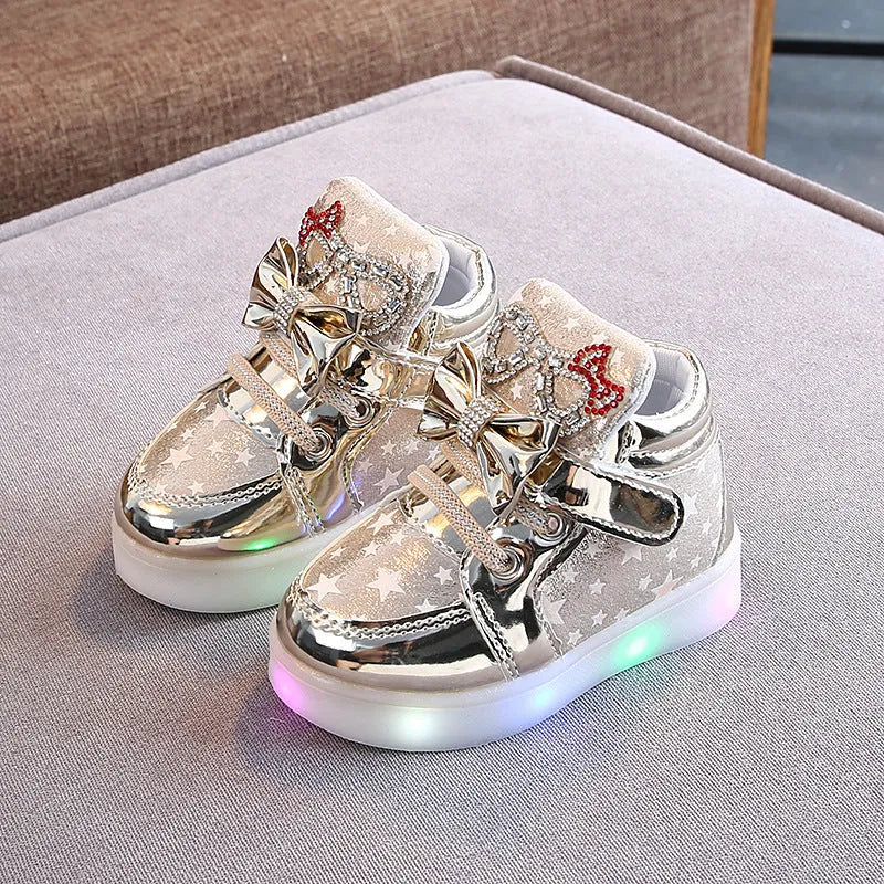 LED magic button sneakers in golden, pink, and silvery metallic finishes with illuminated soles