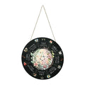 Square wooden holiday pendant with decorative disc designs on a white background.