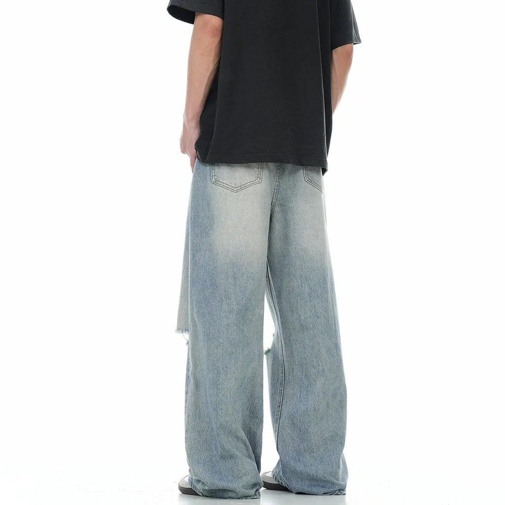 Blue straight-leg jeans with ripped detailing on cotton blend fabric