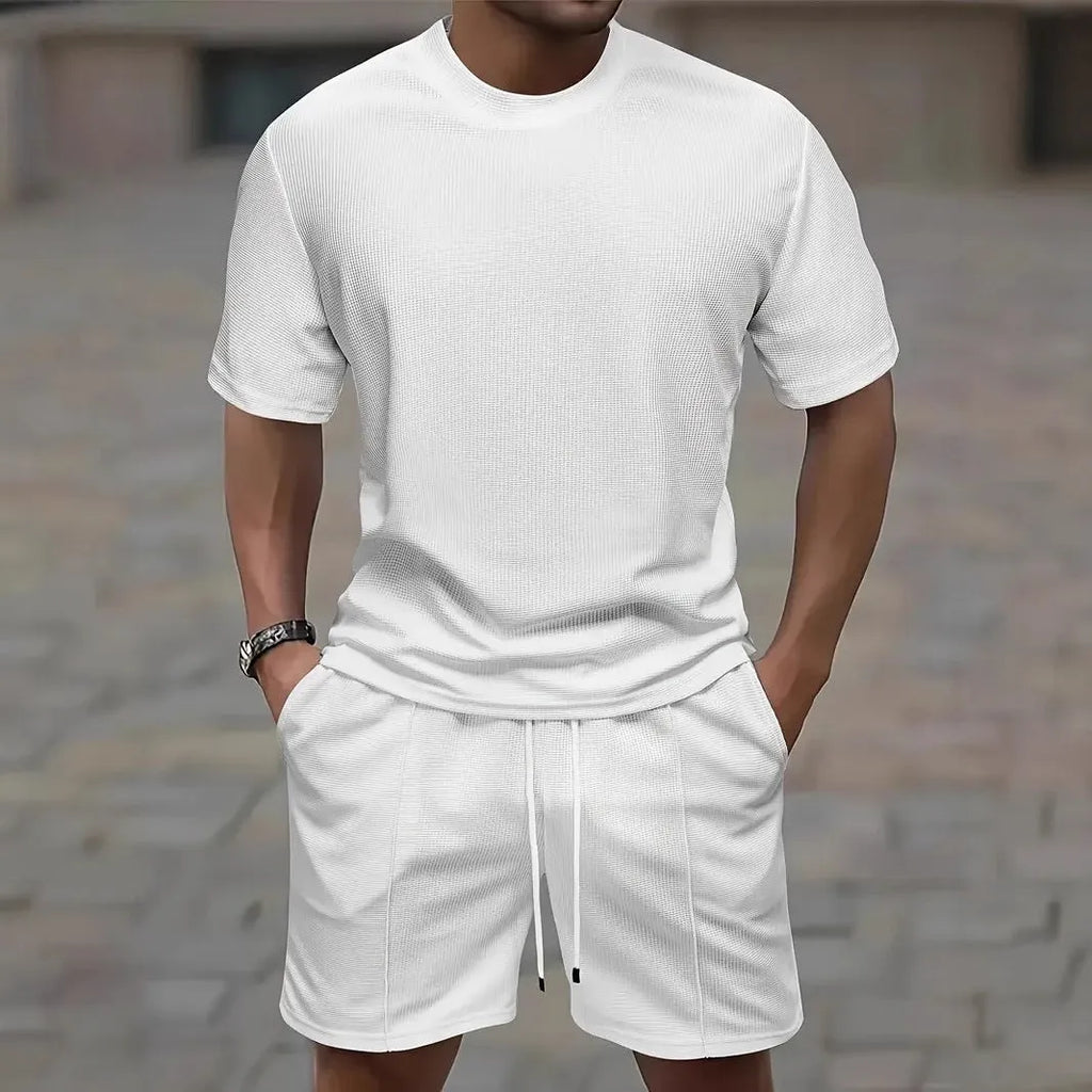 Man wearing a light waffle-texture short sleeve blouse and matching shorts in apricot colour.