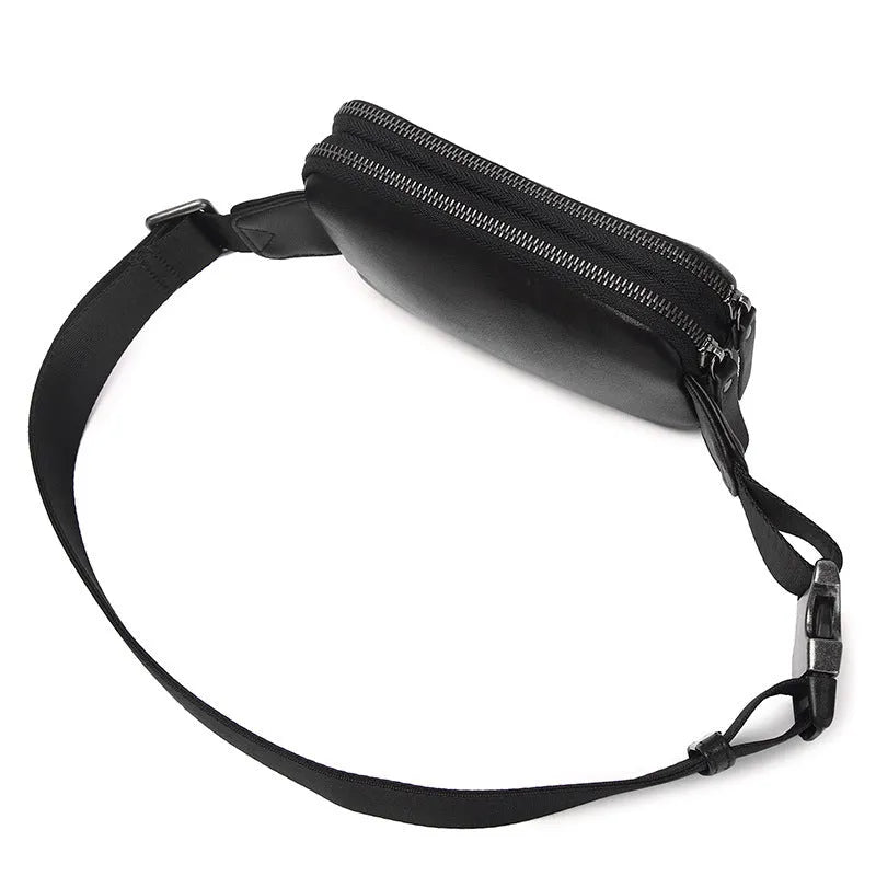 Men's small leather crossbody bag in black showing 17cm width dimensions
