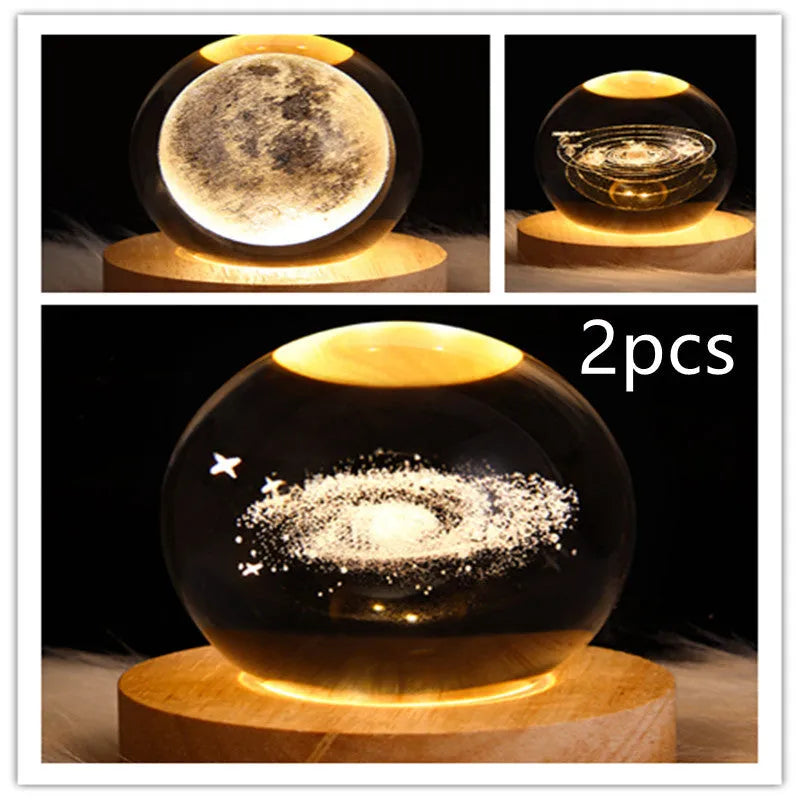 LED galaxy crystal ball night light with 3D planet designs on a table