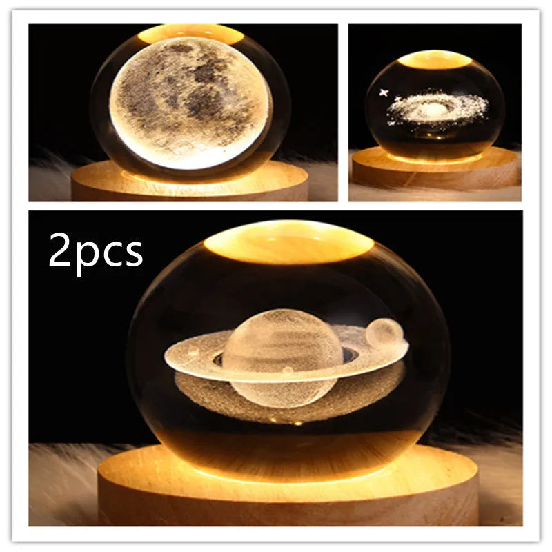 LED galaxy crystal ball night light with 3D planet designs on a table