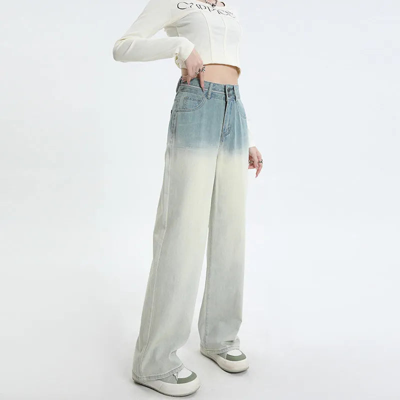Gradient blue women's straight-leg denim trousers on a hanger, showing colour transition.