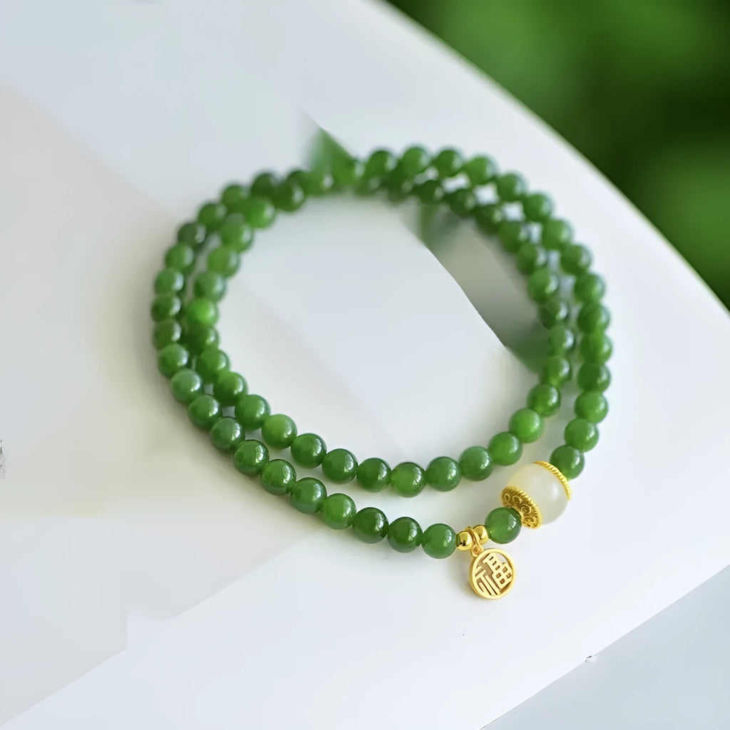 Women's double circle bracelet made from natural Hetian jade with 6mm geometric beads and a fu charm.