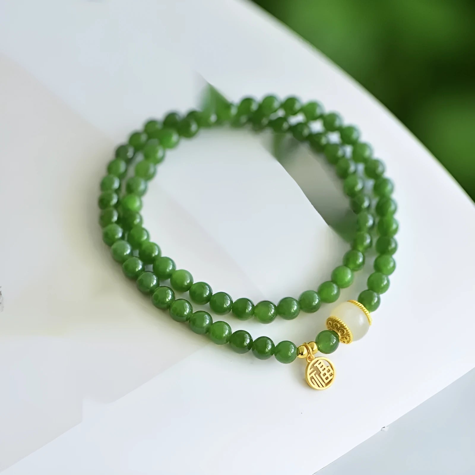 Women's double circle bracelet made from natural Hetian jade with 6mm geometric beads and a fu charm.