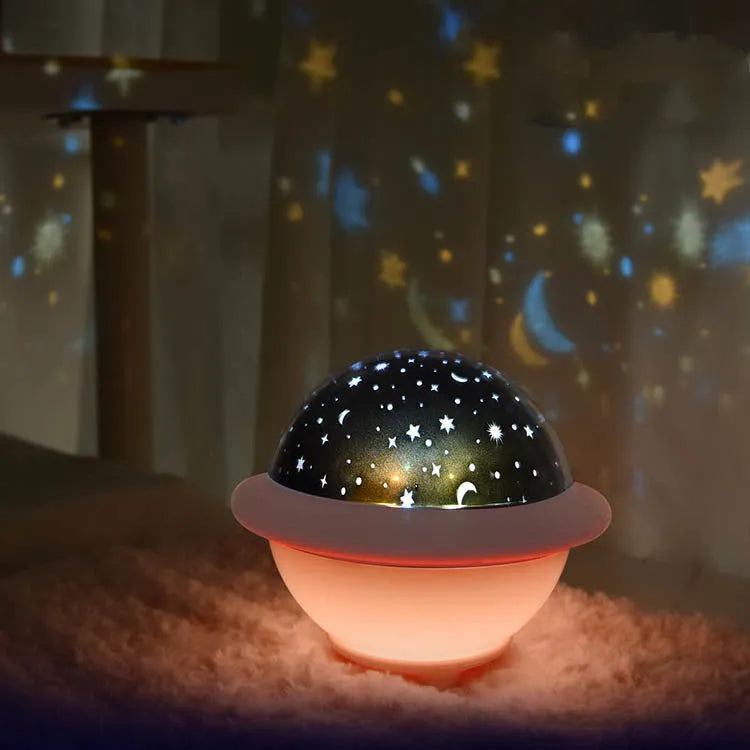 UFO-shaped starry sky projection night light in pink colour showing star projection effect