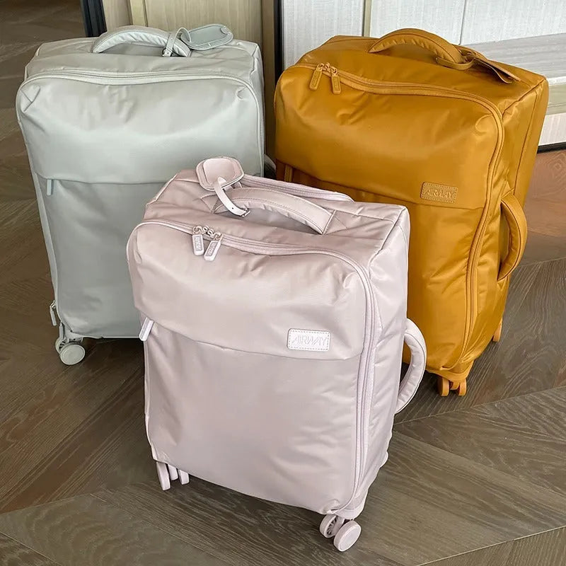 Waterproof Oxford cloth suitcase with universal wheels in six colour options including tea brown and haze blue