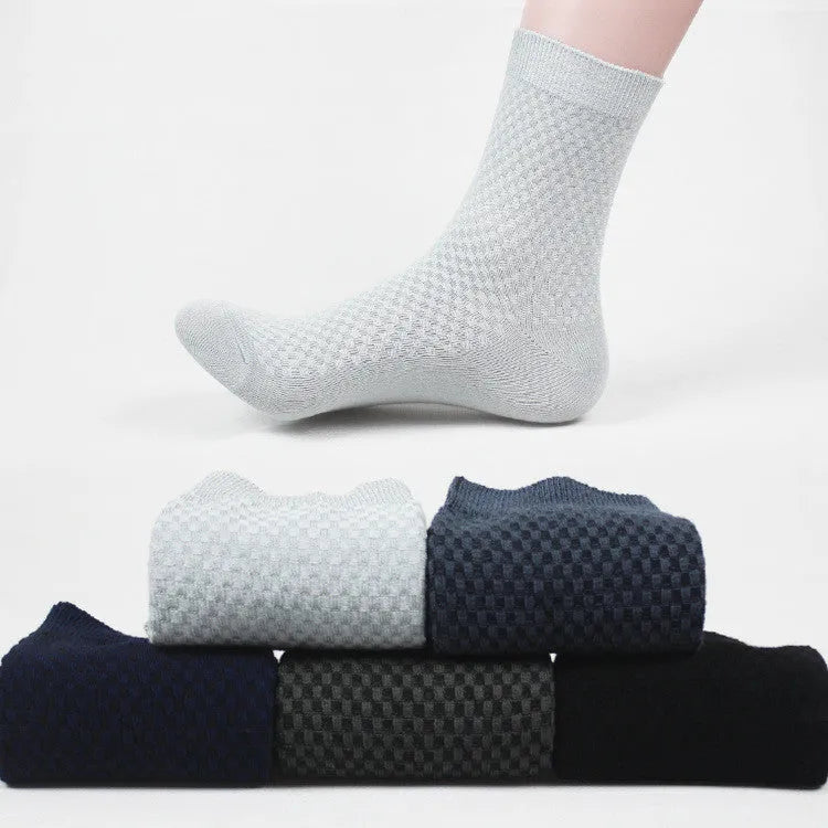 Men's bamboo fibre business socks in grey with a small-square pattern, shown on a foot.