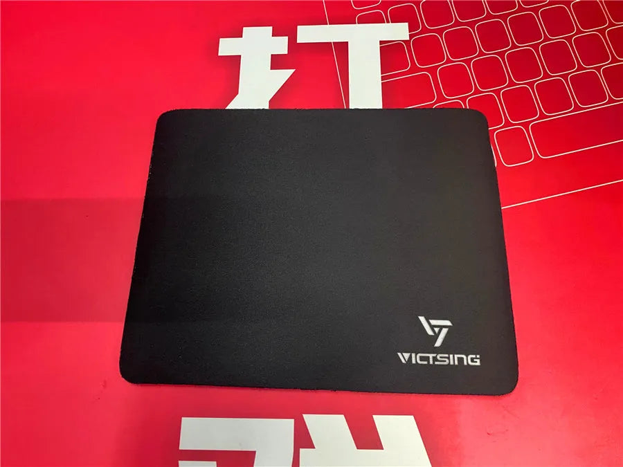 Black thickened rubber gaming mouse pad with rough grain textured surface measuring 270mm by 220mm