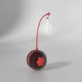 Self-moving cat teaser stick with feather and hemp rope attachments on a red base with USB charging cable