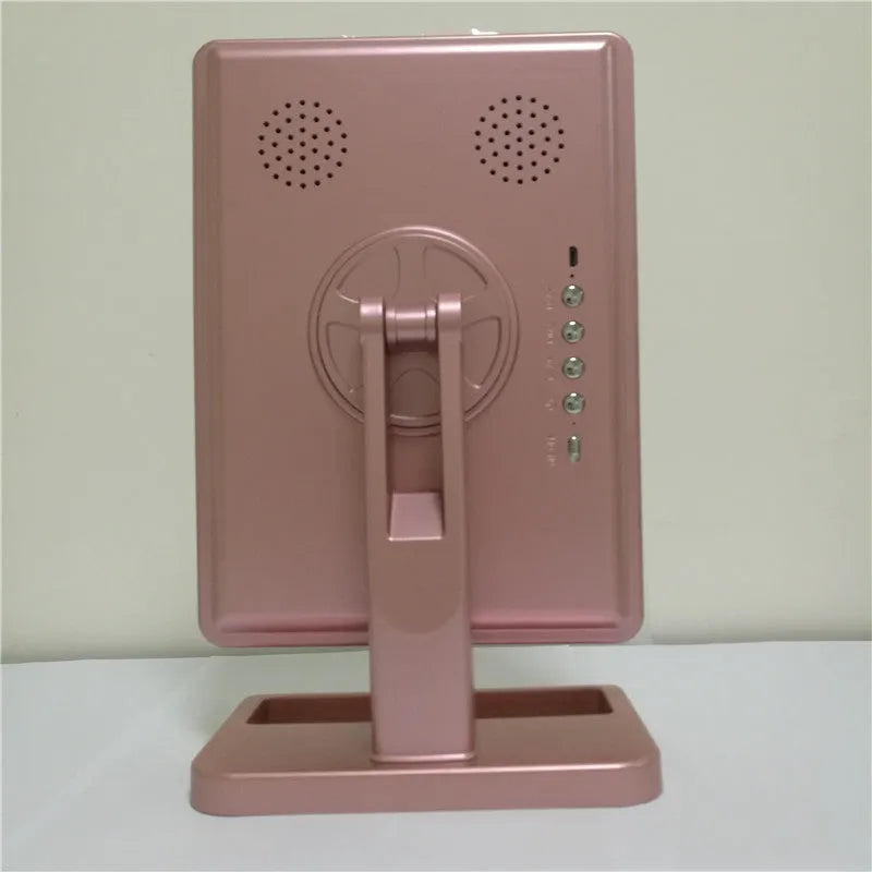Pink touch screen makeup mirror with ring of LED lights, Bluetooth speaker, and a 10x magnifying section.
