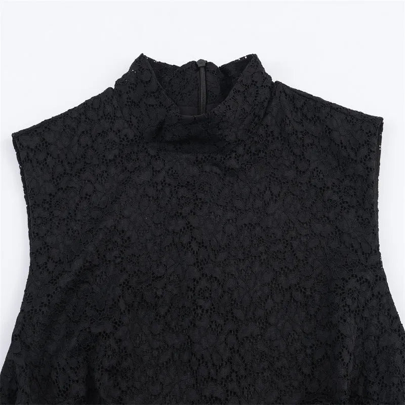 Women's black cotton short dress with lace stitching and asymmetric skirt on a plain background