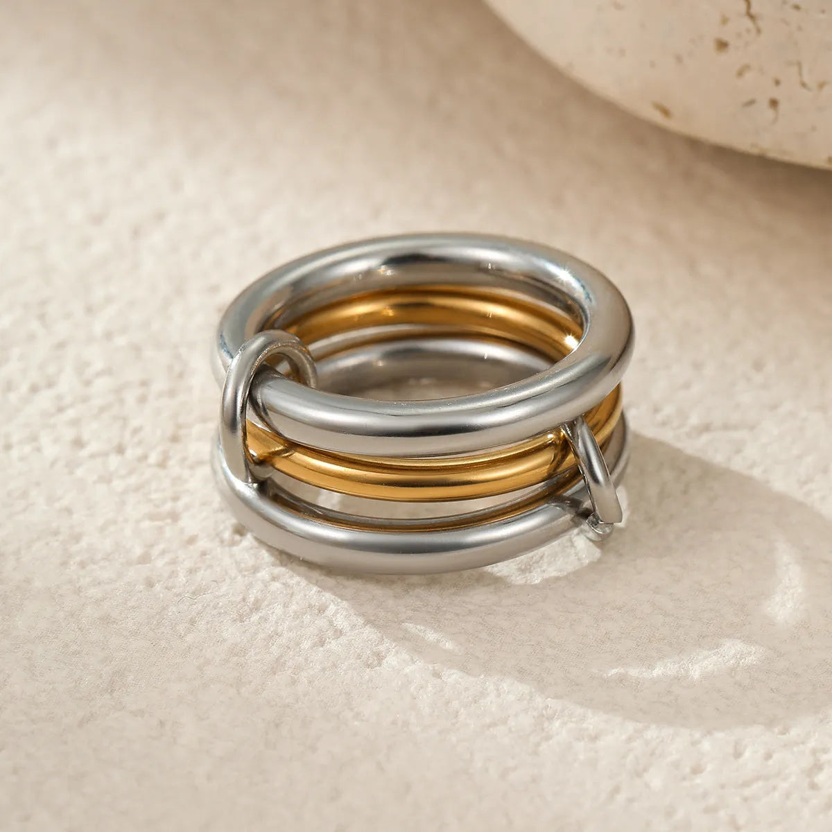 Three gold-plated geometric stacking rings with adjustable free size on hand