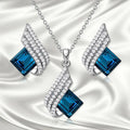 Alloy necklace with glass pendant and matching ear studs featuring cross chain design in jewellery set