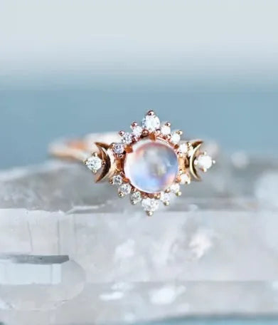 Five stackable fashion rings in gold and rose gold finishes on a white background