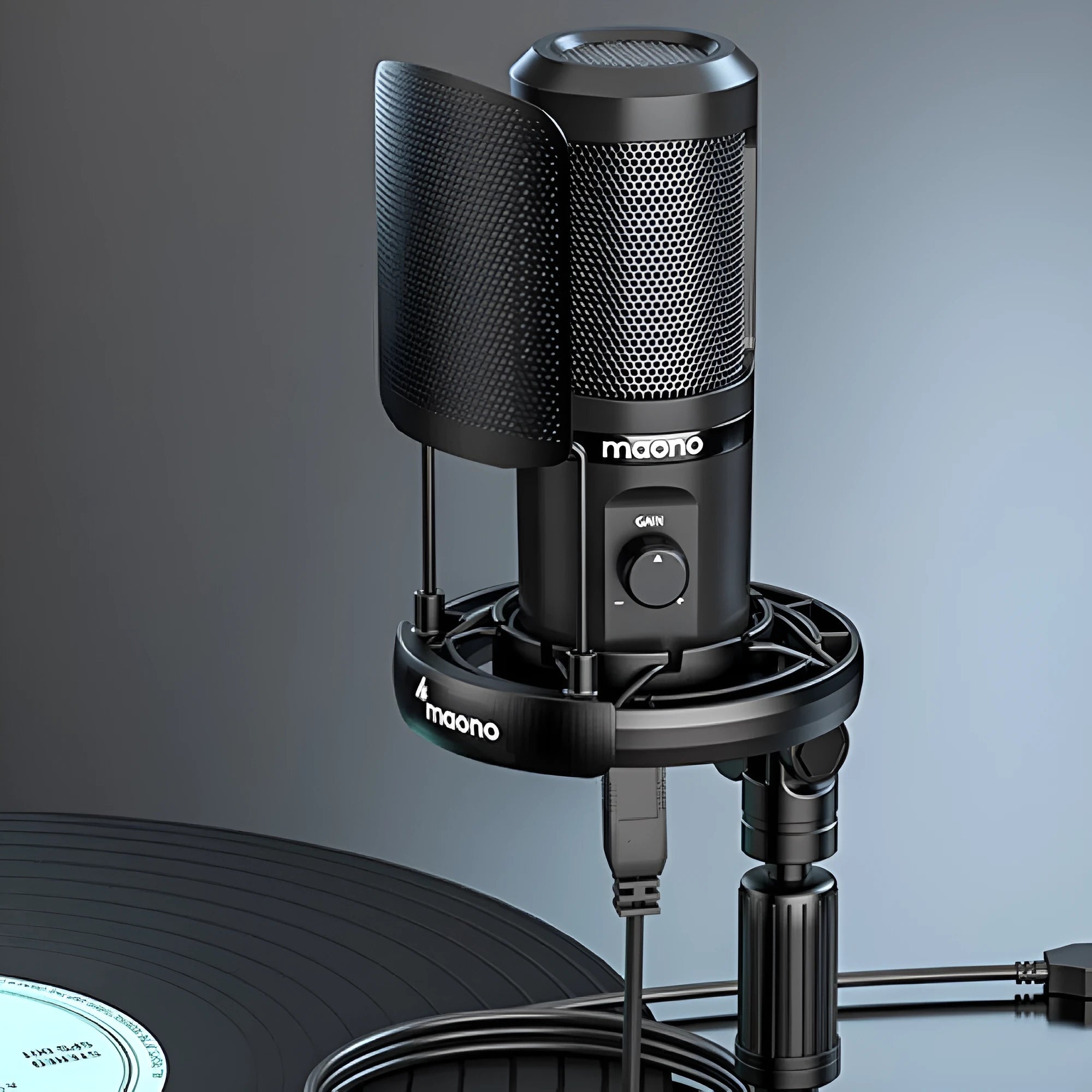 Black USB condenser microphone on a tripod with shock mount, next to a USB cable.