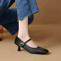Women's black square toe stiletto heel ankle-strap shoes with horse hair upper on a model.