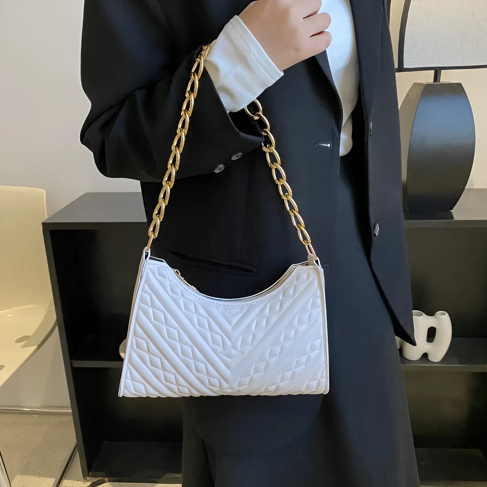 Vertical brown PU leather women's shoulder bag with a pleated front, chain strap, and soft handle.