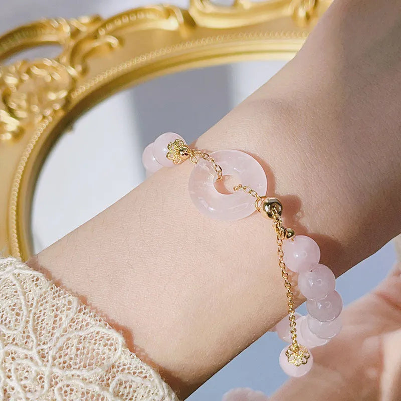 Pink crystal peace buckle bracelet with safety clasp on silver-coloured chain